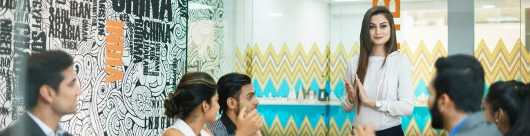 Woman presenting to her colleagues in India based office