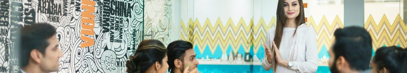 Woman presenting to her colleagues in India based office
